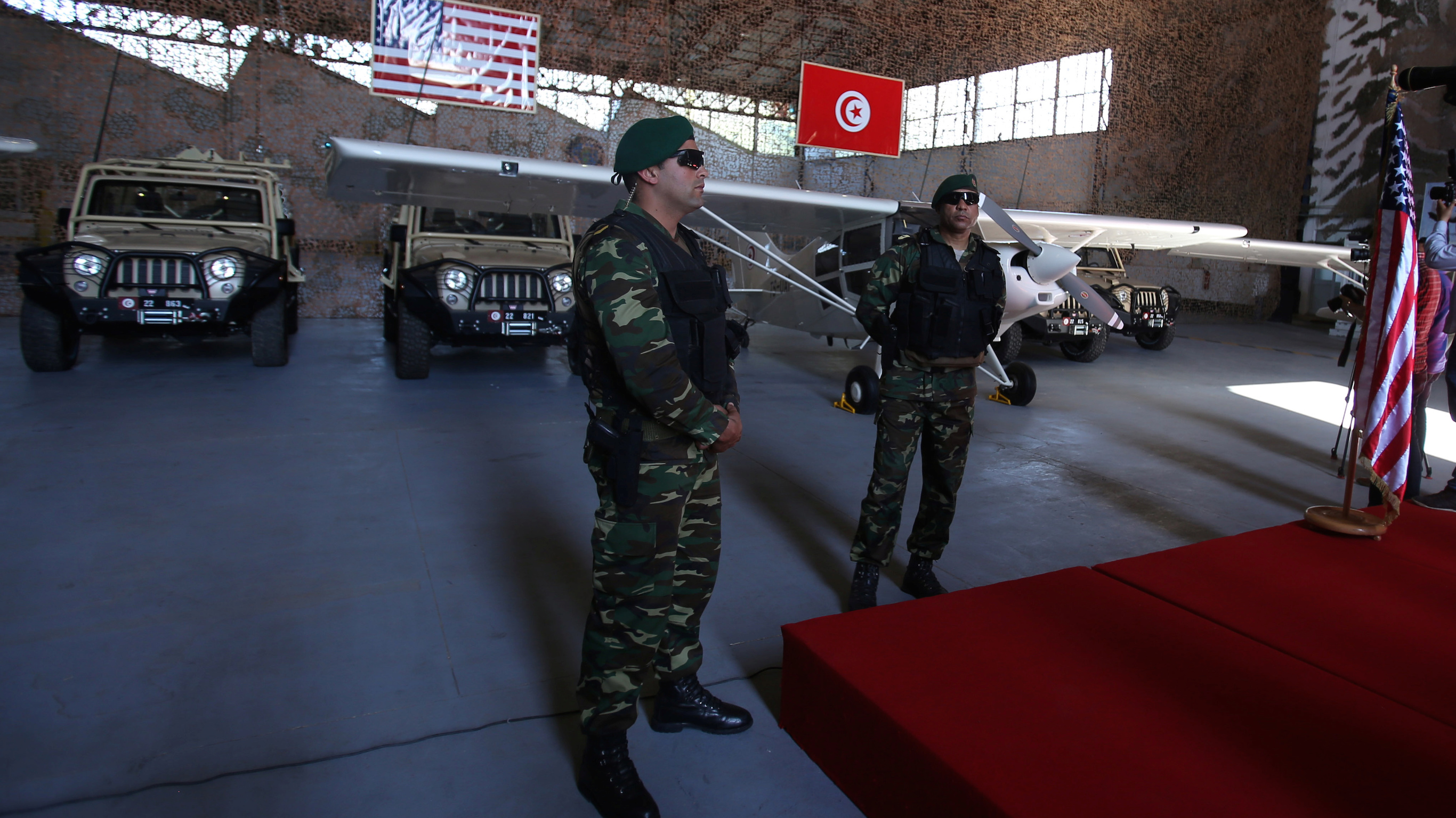 Tunisian soldiers stand in front of military equipment offered to Tunisia by the United States, in Tunis