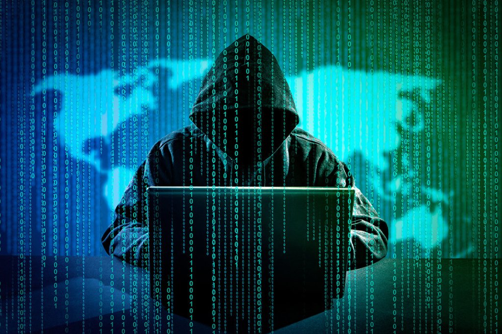 Man on laptop hacking computer. 